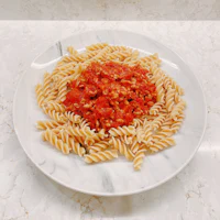 pasta with tomato sauce on a white plate