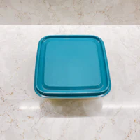 a blue plastic container sitting on a marble counter