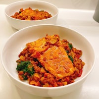 two bowls of food on a counter