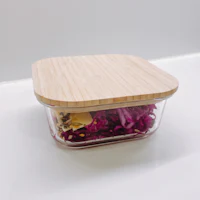 a wooden container with a lid filled with food
