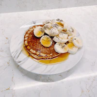 a plate with pancakes and bananas on it