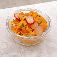 a bowl filled with carrots and radishes