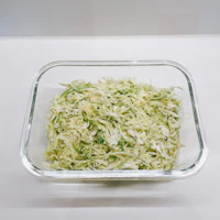 shredded cabbage in a glass bowl on a table