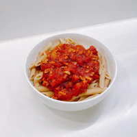 penne with tomato sauce in a white bowl