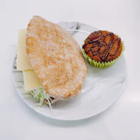 a sandwich and a muffin on a plate