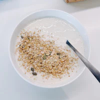 a bowl of granola with a spoon in it
