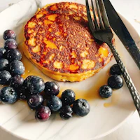 pancakes with blueberries and syrup on a plate