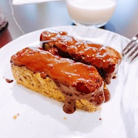 a piece of chocolate cake on a plate next to a glass of milk