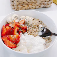 a bowl filled with yogurt, strawberries and bananas
