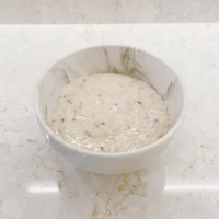 a bowl of oatmeal sitting on a marble counter