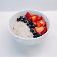 a bowl of oatmeal with berries and blueberries