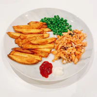 a white plate with peas and potatoes on it