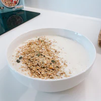 a bowl of granola sitting on a kitchen counter