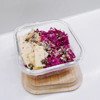 a glass container with a salad in it