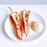 a white plate with two peppers on it